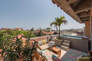 a balcony with a patio furniture and a swimming pool at Townhouse Boutique Hotel in Cartagena de Indias