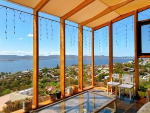 a house with a view of the water at Blue Horizon Retreat - Close to CBD&Airport in Sandy Bay