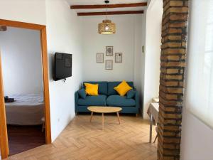 a living room with a blue couch and a table at Encantador piso en Benimaclet in Valencia