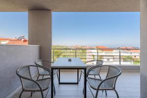a table and chairs on a balcony with a view at Philippos Residences in Leptokarya