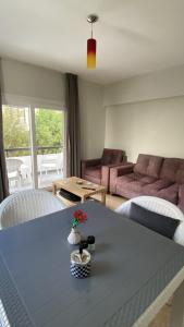 a living room with a table and a couch at 1C Newly renovated 2 bedroom flat in Kumsal +3 photos