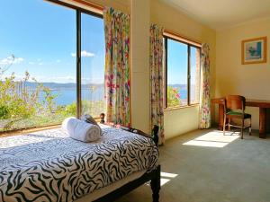a bedroom with a bed and a large window at Blue Horizon Retreat - Close to CBD&Airport in Sandy Bay