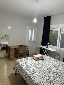 a bedroom with a bed and a desk and a table at 1C Newly renovated 2 bedroom flat in Kumsal