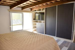 a bedroom with a bed and a large window at Las Blanquitas- departamento en el centro de Chascomús, a pocos metros de la laguna in Chascomús
