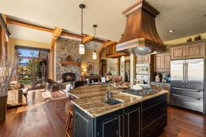 a kitchen with a sink and a stove at Cowboy Lake Lodge in Emigrant