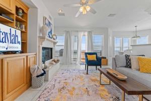 a living room with a couch and a fireplace at Beachfront Vilano Retreat in Saint Augustine