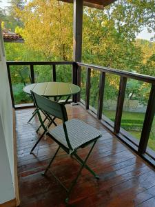 a green chair and a table on a porch at Black Sea Villa in Varna City