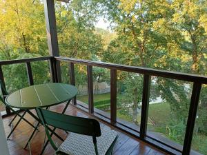 a balcony with a glass table and chairs on it at Black Sea Villa in Varna City