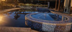 a swimming pool in the middle of a building at Hotel la quinta campestre in Villavicencio +3 photos