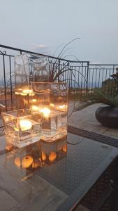 a group of glasses with lights on a table at BlueSky in Mascali +20 photos