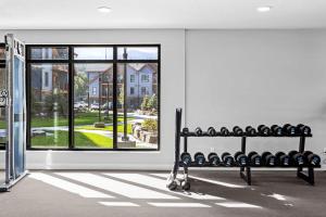 a room with a bench in front of a window at Pool and hot tub Stunning 2Bd haven in the Rockies in Dead Man's Flats