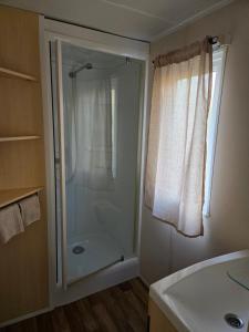 a bathroom with a shower and a sink at Mobil-home Beau Rivage in Gunsbach