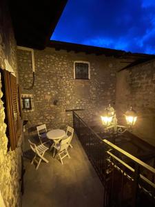 a patio with a table and chairs on a balcony at MaMa's Home in Abbadia Lariana