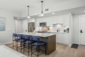 a kitchen with a large island with blue bar stools at Outdoor heated pool and hot tub Stunning 3Bd sanctuary in Dead Man's Flats