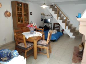 a living room with a table and chairs and a staircase at da nonna Ida in Civita Campomarano +30 photos