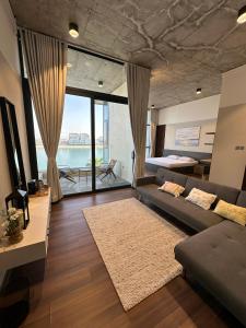 a living room with a couch and a large window at Ymm in An Nāmī