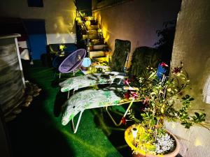a room with a table and chairs and plants at Casa Rural al Sol De Las Ruinas- piscina privada in Belchite