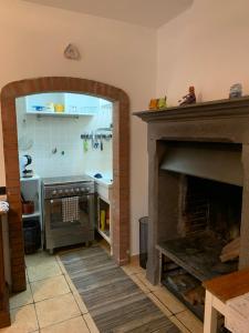 a kitchen with a stove and a fireplace at Alloggio da Mary in Canale Monterano