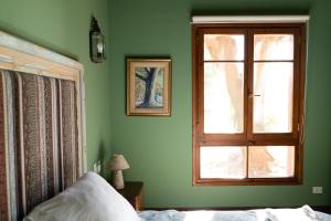 a green bedroom with a window and a bed at El Lucero - Casa de Campo * in Lobos +27 photos