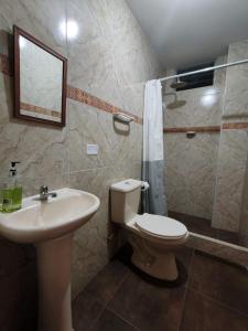 a bathroom with a toilet and a sink and a shower at Catag Wasi Casa hospedaje in Cajamarca