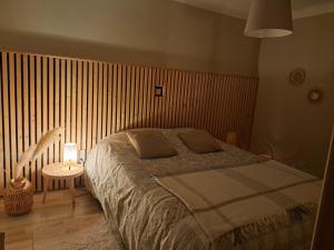 a bedroom with a bed and a table with a lamp at le refuge du bonheur in Bitche +24 photos
