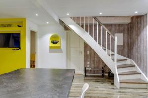 a white staircase in a room with a yellow wall at Cozy 2 rooms apartament close to the nature in Kongsberg