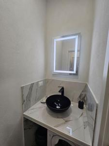 a bathroom with a black sink and a mirror at La Casa di Colombetta in Badalucco +32 photos