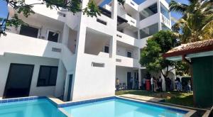 a building with a swimming pool in front of a building at Ro Rich Villa in Negombo
