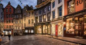 a street in an old city with stores at Pass the Keys Spacious Murrayfield Flat in Edinburgh