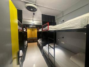 a group of bunk beds in a room at Travotale Hostel and CoWork Koregaonpark Pune in Pune