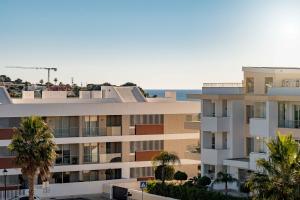 an apartment building with the ocean in the background at Lagos Ocean View 2 With Pool by Homing in Lagos