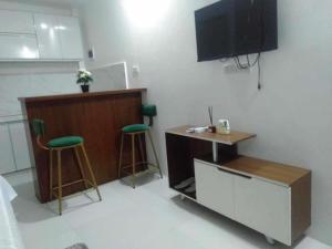 a room with a desk and two stools and a tv at JP Suites & Residences in Tayabas +12 photos