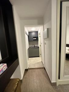 a hallway leading to a room with a kitchen at central apartment for rent 23 in Umm Uthainah