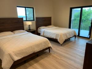 a bedroom with two beds and a balcony at New Constructed Home in Poway in Poway