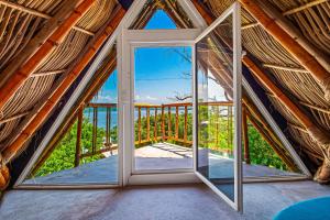 an open door in a room with a balcony at Villa Buganvilia in Barra de Navidad