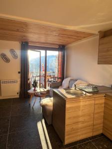 a kitchen with a sink and a living room at Stunning apartment with breathtaking view! in LʼHuez
