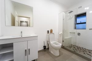 a bathroom with a toilet and a sink and a shower at Contours Platinum Peak , Victoria Falls in Victoria Falls +38 photos