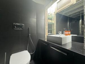 a bathroom with a white toilet and a sink at In Ancient Rome Apartment in Rome +12 photos