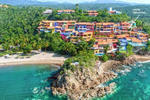 an aerial view of a resort on a beach at Casita Hermanitas - 3 bedroom panoramic ocean views with private cook in Careyes