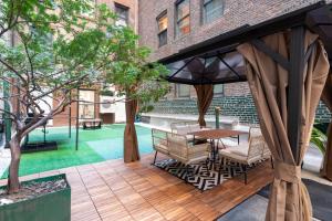 a gazebo with a table and chairs on a patio at Modern 3Bd Rose Hills Manhattan Terrace Space in New York