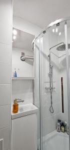 a white bathroom with a shower and a sink at Mieszkanie dwupokojowe z balkonem, blisko parku in Jastrzębie Zdrój