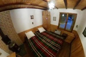 an overhead view of a room with a bed and a window at Ski liviomoritz at gma il com Chalet in Madzhare