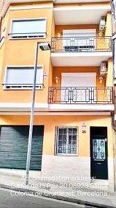 an apartment building with two balconies and a street at Warm Harbor in Santa Coloma de Gramanet