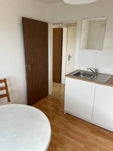 a kitchen with a table and a sink and a counter at Studio Jan in Hombrechtikon