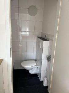 a small bathroom with a toilet in a stall at Studio Jan in Hombrechtikon