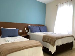 Ένα ή περισσότερα κρεβάτια σε δωμάτιο στο Pousada Moça Bonita +33 φωτογραφίες