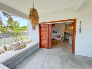a living room with a couch and a large window at Casa Devagar Icaraizinho in Amontada