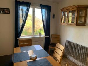 a dining room with a table and a window at Hus Björk in Fågelfors