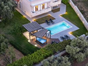an aerial view of a house with a swimming pool at Villa Amalia in Áyios Vasílios