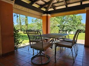 a table and chairs on a porch with a view at Villa Arbolada in San Lorenzo